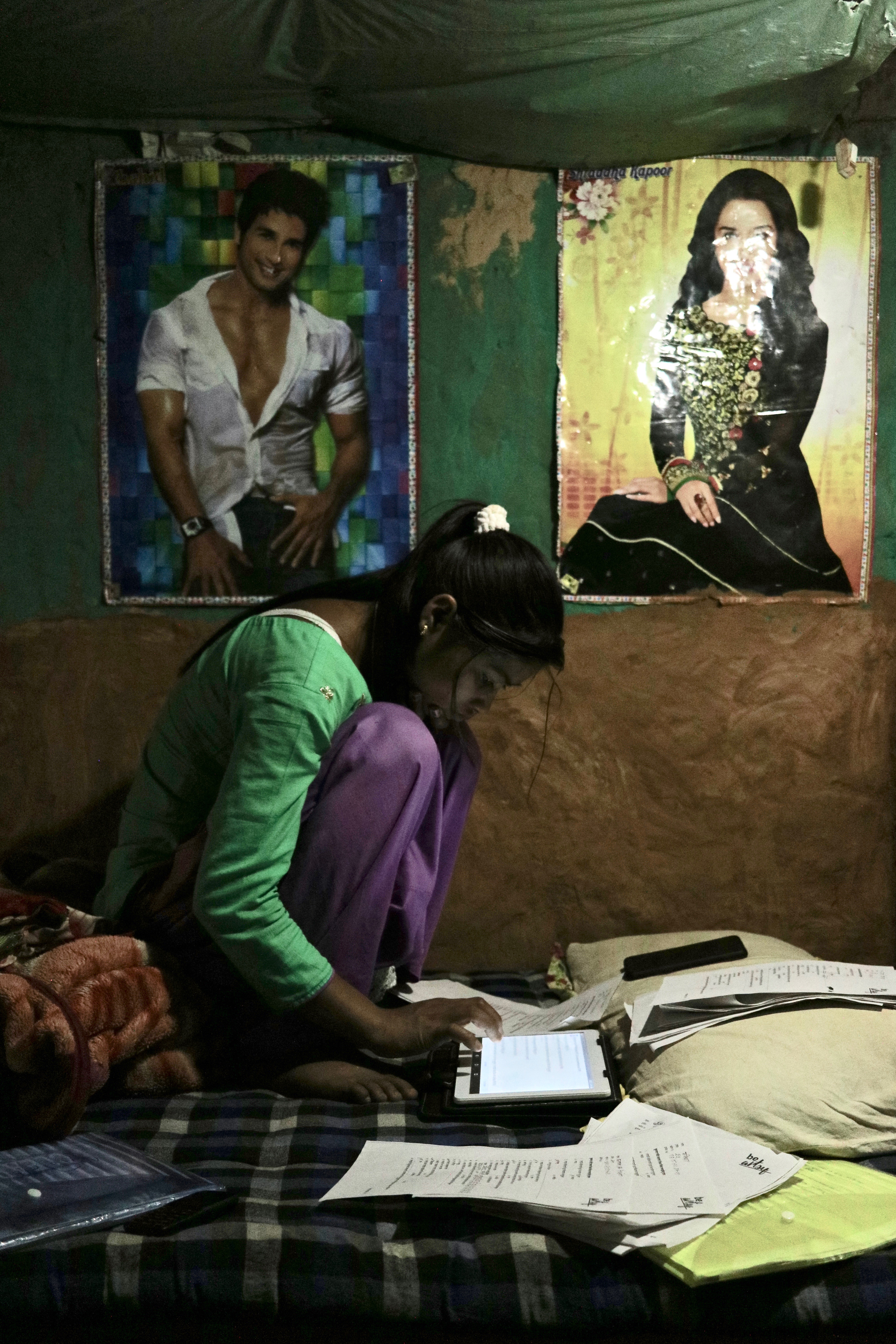 A girl learning and working with a tablet, in Nepal