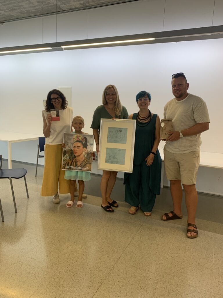 Participants with artworks after the charity art auction in Ullà
