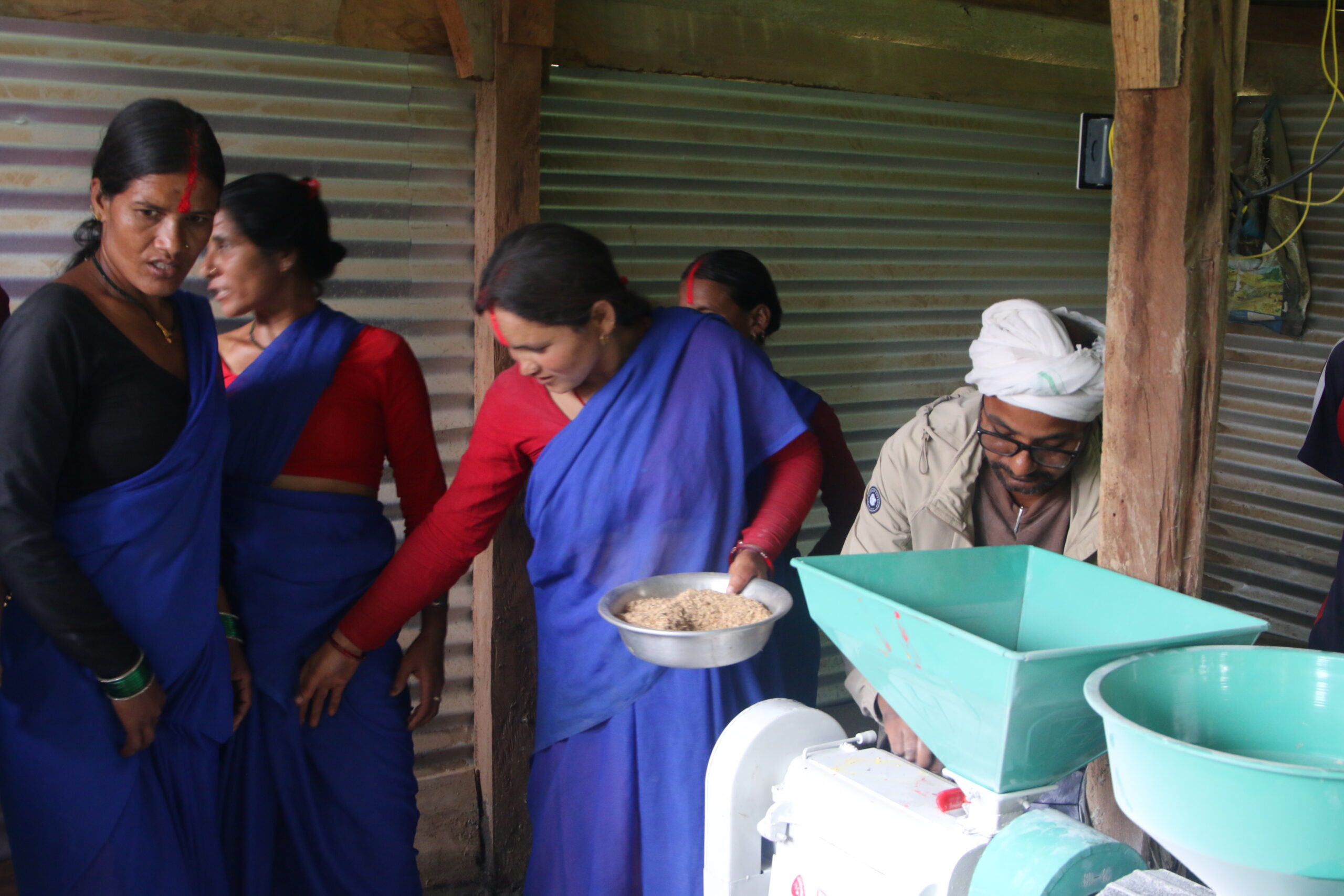 Women in Bhatwada begin using the newly installed community mill