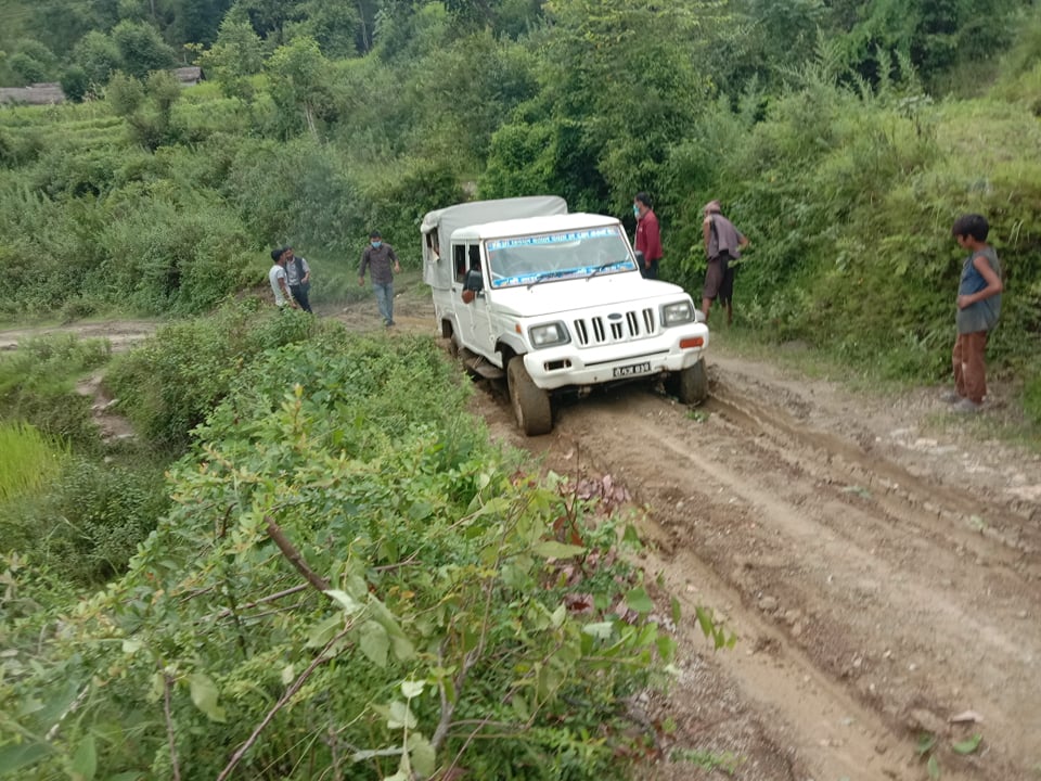 Jeep on a difficult muddy road in rural Nepal