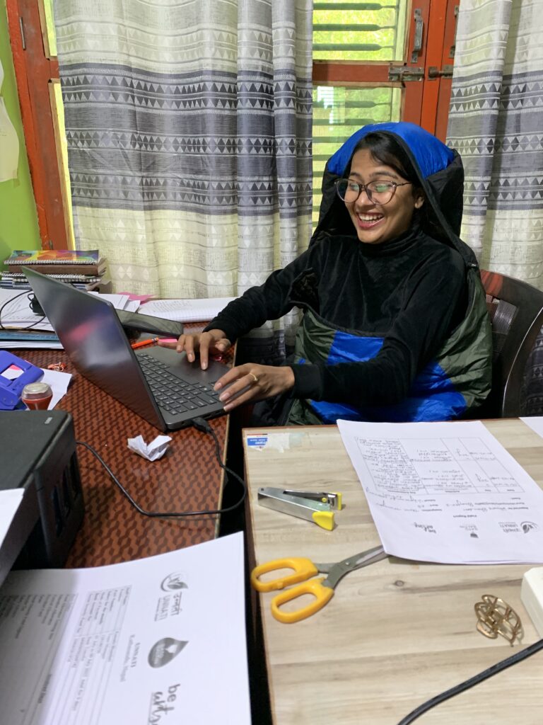 Colleague working with a laptop and documents in Nepal