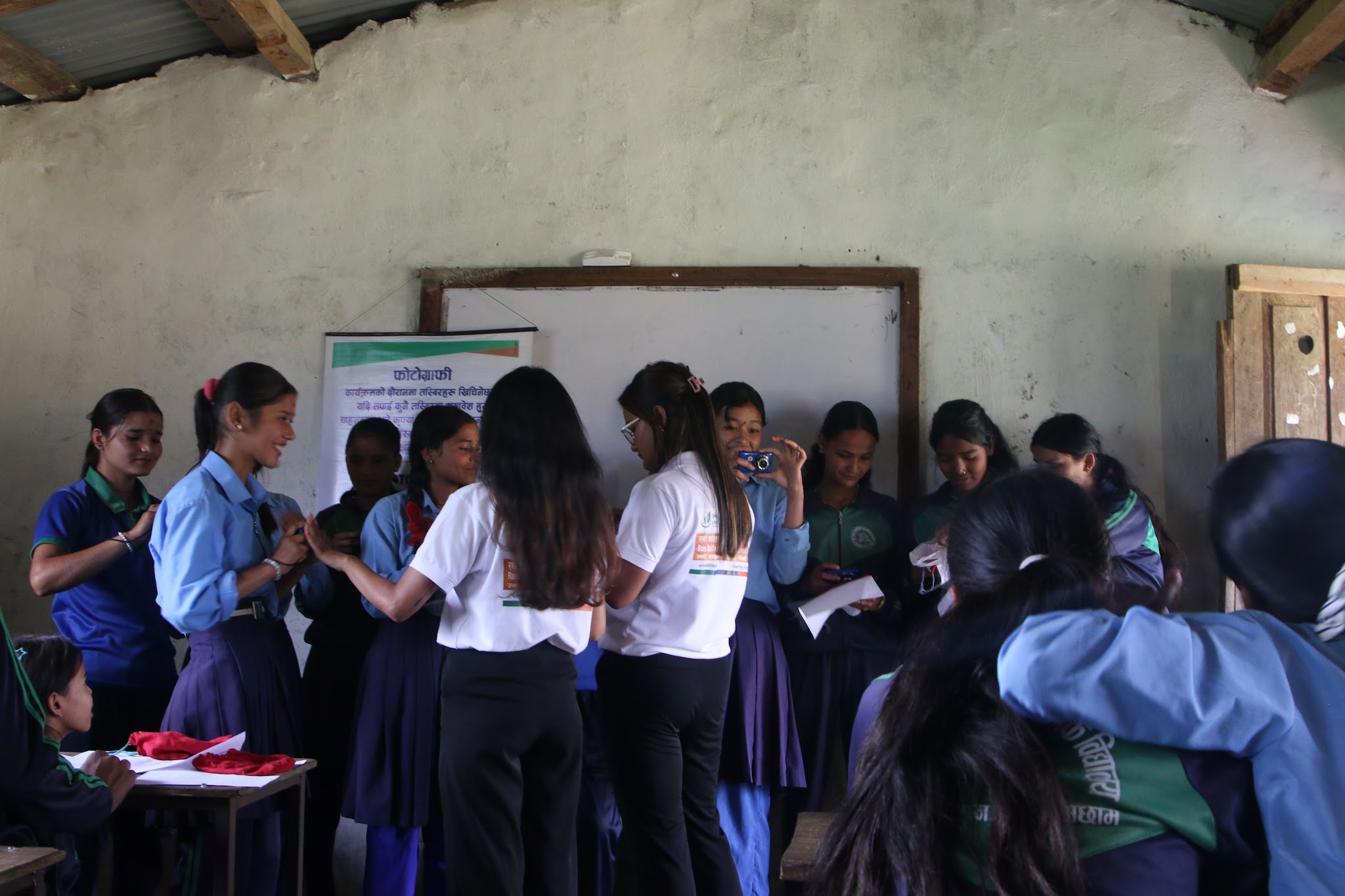 Una formadora acompaña a las chicas durante una actividad de fotografía participativa de Rato Baltin.